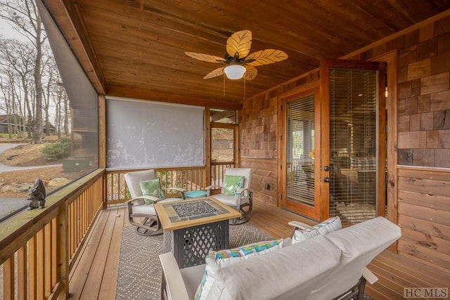 sunroom / solarium featuring ceiling fan and wooden ceiling