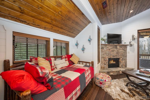 bedroom with hardwood / wood-style floors, wooden walls, a fireplace, lofted ceiling, and wooden ceiling