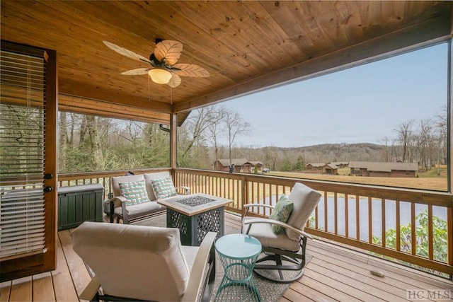 deck featuring an outdoor living space with a fire pit and ceiling fan