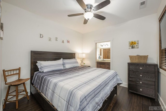 bedroom featuring ensuite bathroom, dark wood-type flooring, and ceiling fan