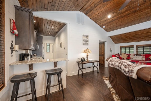 bedroom with dark hardwood / wood-style flooring, vaulted ceiling, and wooden ceiling