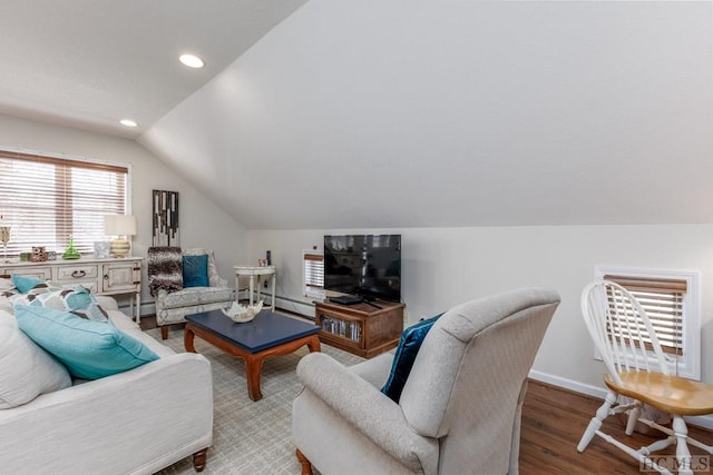 living room featuring hardwood / wood-style flooring, lofted ceiling, a baseboard heating unit, and a wealth of natural light