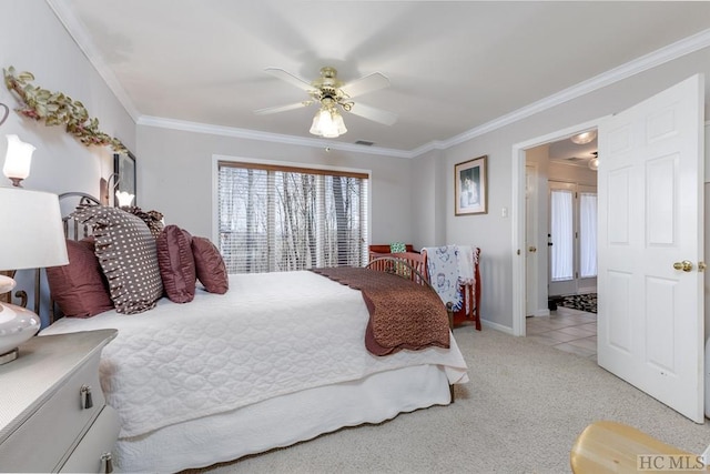 carpeted bedroom featuring ornamental molding and ceiling fan