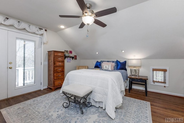 bedroom featuring multiple windows, dark wood-type flooring, ceiling fan, and vaulted ceiling