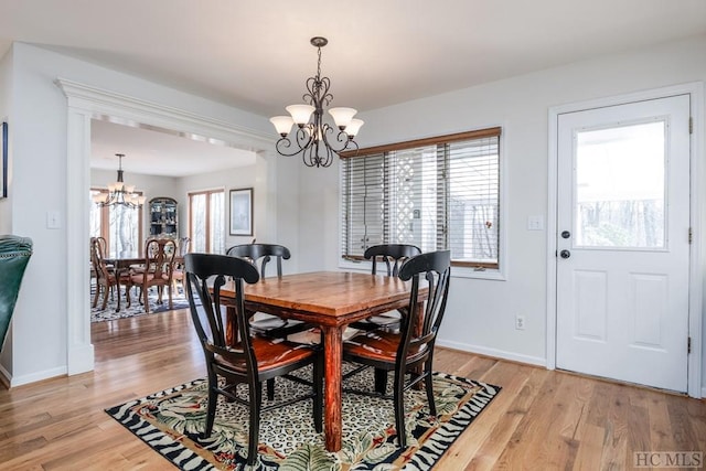 dining room featuring an inviting chandelier and light hardwood / wood-style floors