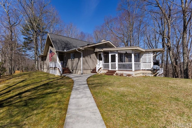 view of front facade featuring a sunroom and a front yard