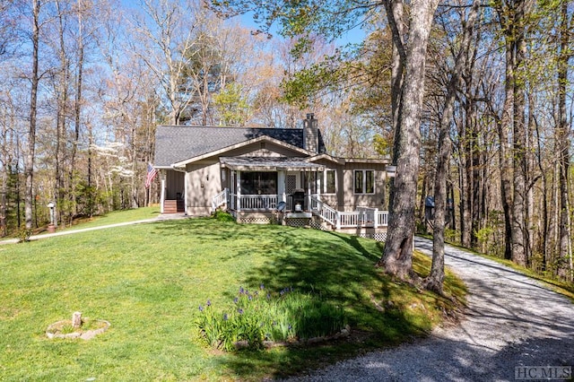 view of front of house featuring covered porch and a front lawn