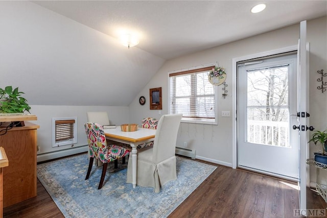 dining room with baseboard heating, vaulted ceiling, and dark wood-type flooring