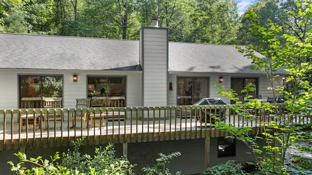 86 Beech Ct, Sapphire, NC 28774 - back of house featuring a shingled roof, a wooden deck, and a chimney