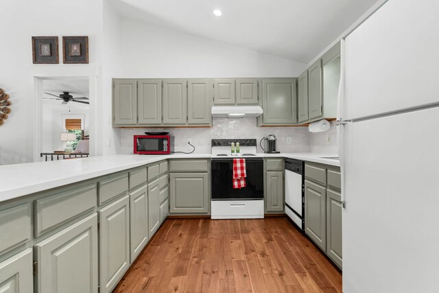 86 Beech Ct, Sapphire, NC 28774 - kitchen with white appliances, under cabinet range hood, backsplash, light countertops, and recessed lighting
