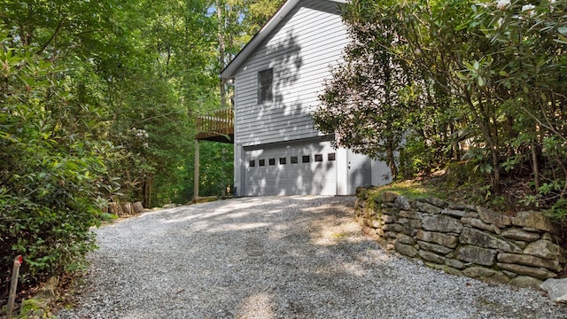 86 Beech Ct, Sapphire, NC 28774 - view of property exterior featuring gravel driveway and an attached garage