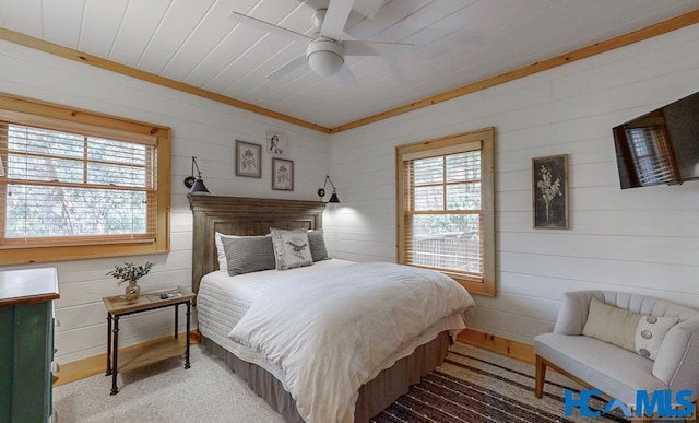 bedroom featuring a ceiling fan, wooden ceiling, and multiple windows