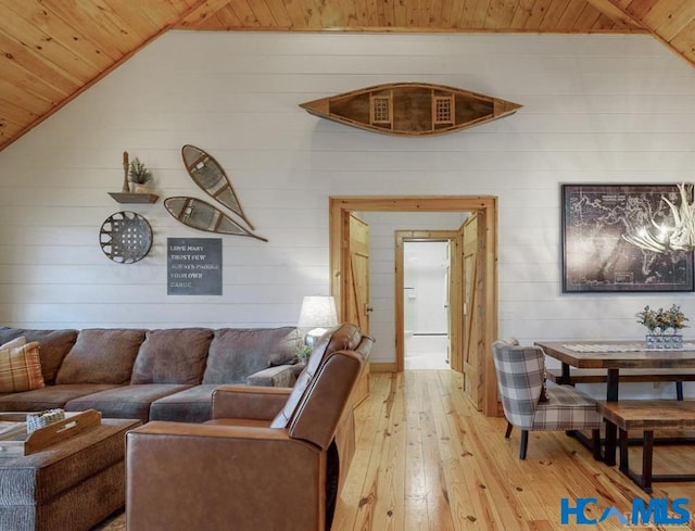 living area featuring light wood-style floors, lofted ceiling, and wooden ceiling