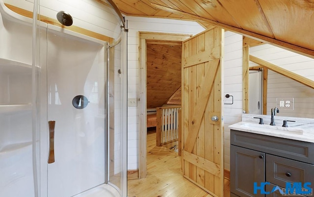 full bath featuring wood walls, wood finished floors, wood ceiling, vanity, and a shower stall