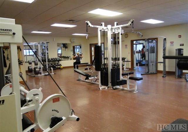 exercise room with a paneled ceiling