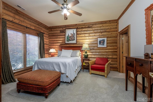 carpeted bedroom with ornamental molding, log walls, and ceiling fan