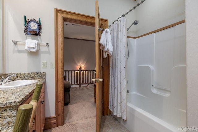 bathroom featuring tile patterned floors, shower / bath combo, and vanity