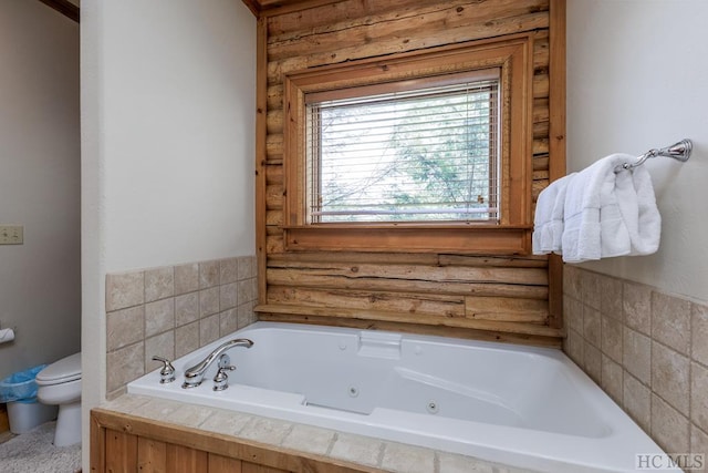 bathroom featuring toilet and tiled tub