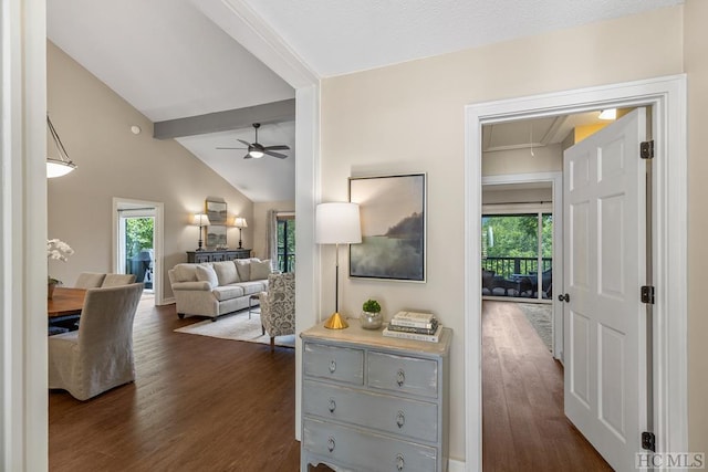 hall featuring dark wood-type flooring and vaulted ceiling with beams