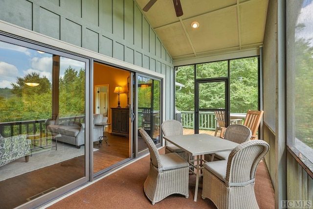 sunroom with vaulted ceiling, plenty of natural light, and ceiling fan