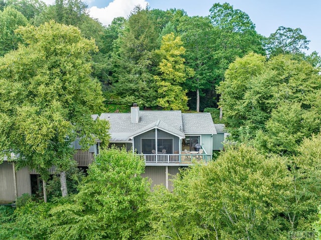 back of house with a wooden deck and a sunroom