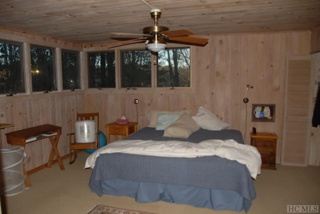 bedroom featuring carpet flooring, wood ceiling, and wooden walls