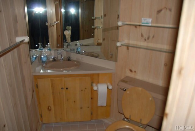 bathroom with vanity, toilet, and tile patterned flooring