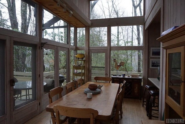 dining room featuring a high ceiling and light hardwood / wood-style floors