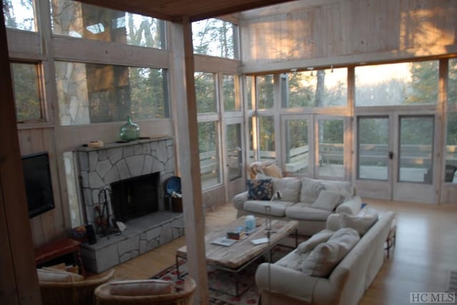 sunroom / solarium featuring a fireplace