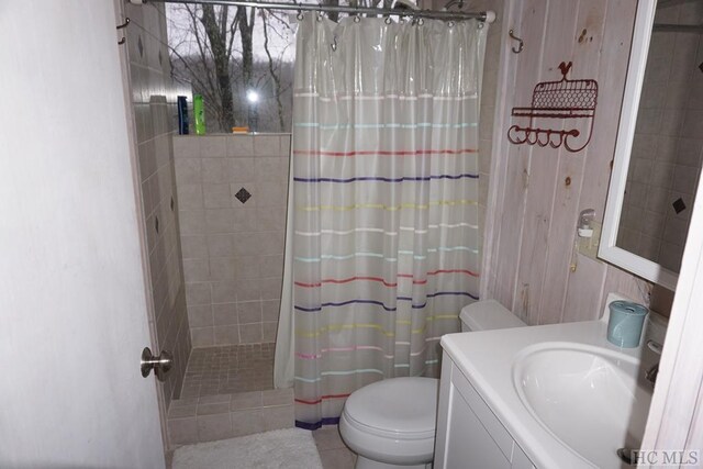 bathroom featuring vanity, toilet, tile patterned floors, and a shower with curtain