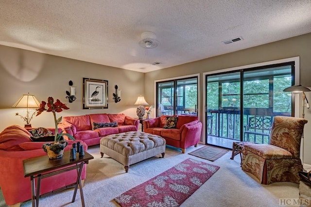 living room with light colored carpet and a textured ceiling