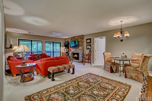 living room with light carpet, a notable chandelier, and a stone fireplace