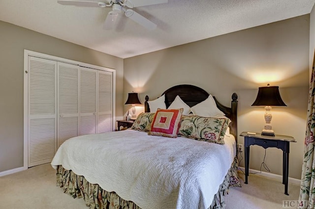 bedroom featuring light colored carpet, a closet, and ceiling fan