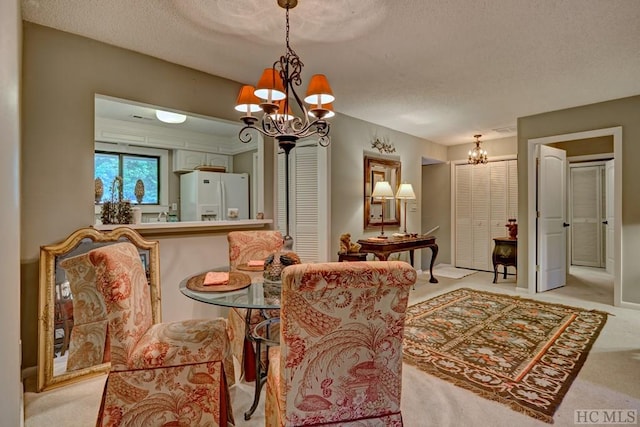 dining area with an inviting chandelier, light carpet, and a textured ceiling