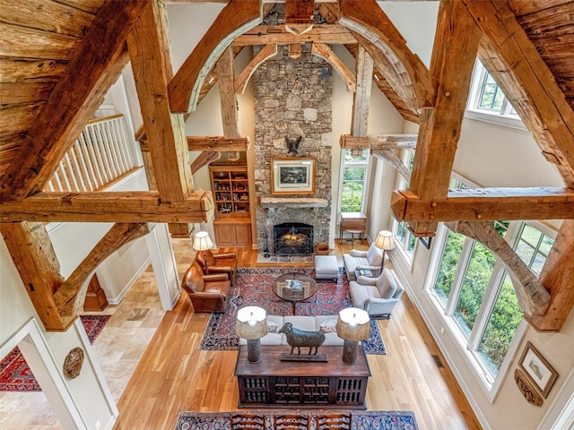 228 Mills Creek Trce, Lake Toxaway, NC 28747 - living area featuring wood finished floors, a fireplace, lofted ceiling, and baseboards