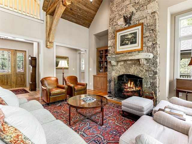 228 Mills Creek Trce, Lake Toxaway, NC 28747 - living area with a fireplace, baseboards, wood ceiling, and high vaulted ceiling