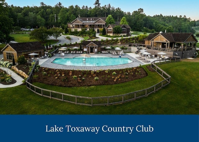 pool with a yard and fence