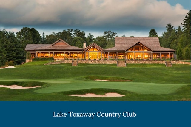 surrounding community with a lawn and view of golf course