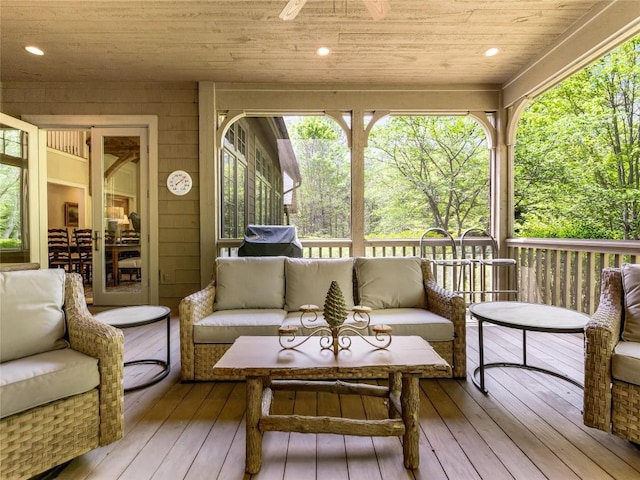 sunroom / solarium with an outdoor hangout area and a ceiling fan