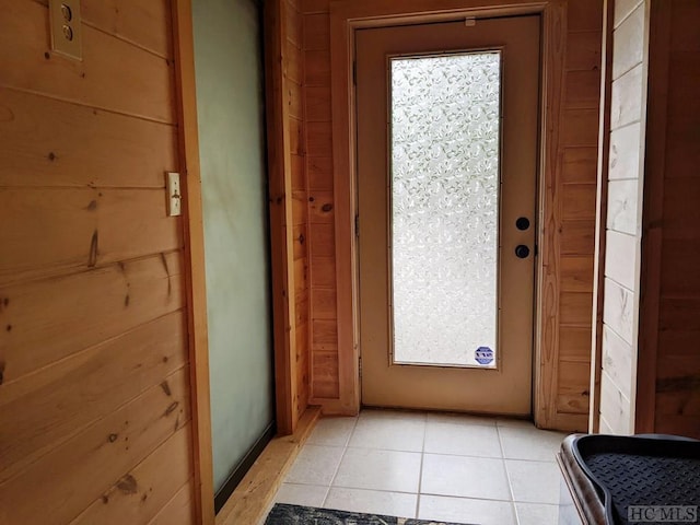 doorway to outside featuring light tile patterned flooring