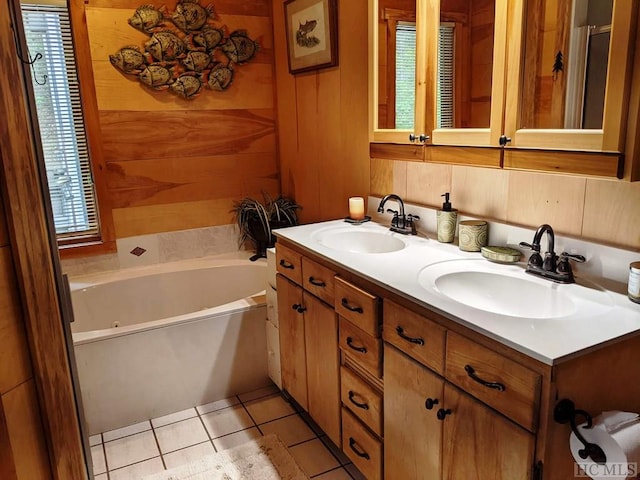 bathroom with a washtub, tile patterned floors, a healthy amount of sunlight, and wood walls