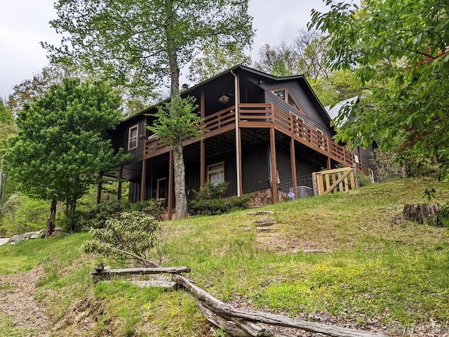 rear view of property featuring a wooden deck