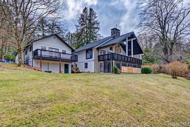 back of house with a wooden deck and a yard