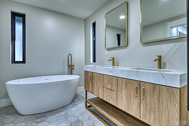 bathroom featuring vanity, tile patterned flooring, and a tub