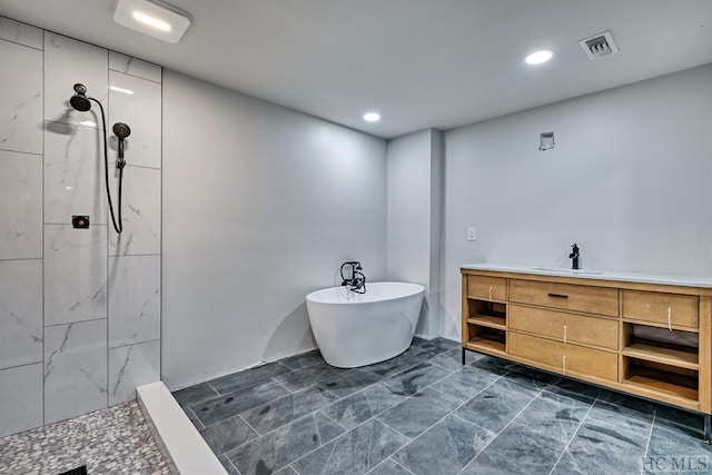 bathroom featuring vanity and plus walk in shower