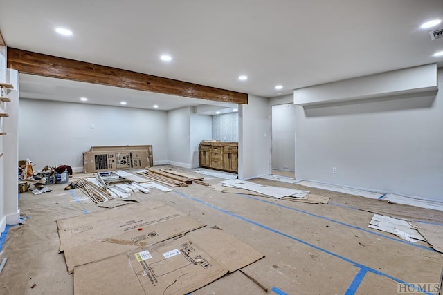 unfurnished living room featuring beam ceiling