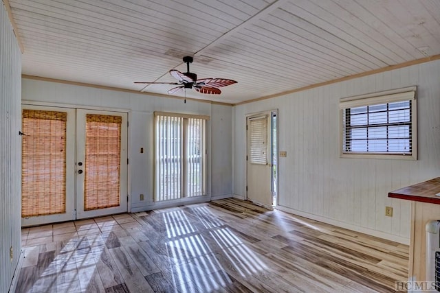 interior space with crown molding, light hardwood / wood-style floors, french doors, and ceiling fan