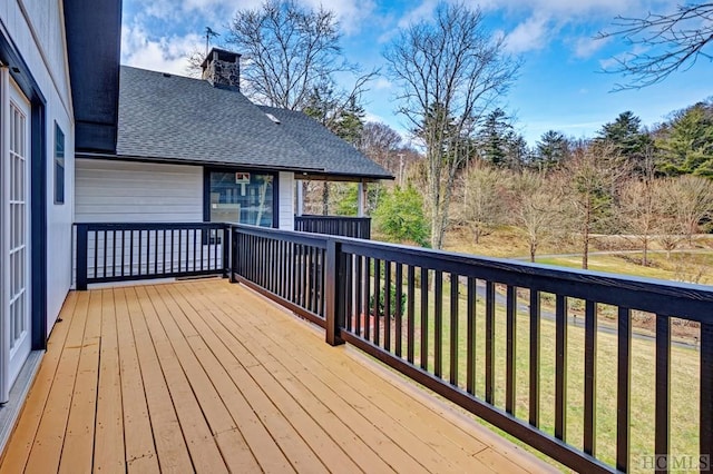 wooden terrace featuring a yard