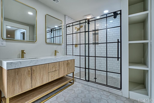 bathroom featuring a shower with door, vanity, and tile patterned flooring