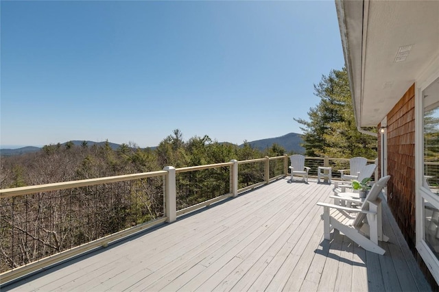 wooden deck featuring a mountain view